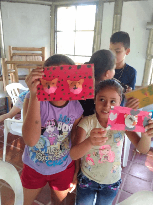 Niños mostrando sus proyectos artísticos terminados